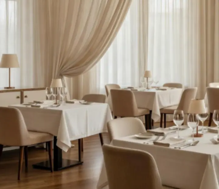 Natural-light filled dining space at Ember Grill Society with linen-toned walls and timber detailing